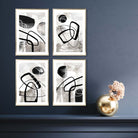 A Set of 4 Black and White Abstract Wall Art in Gold Wooden Frames featuring watercolour shapes