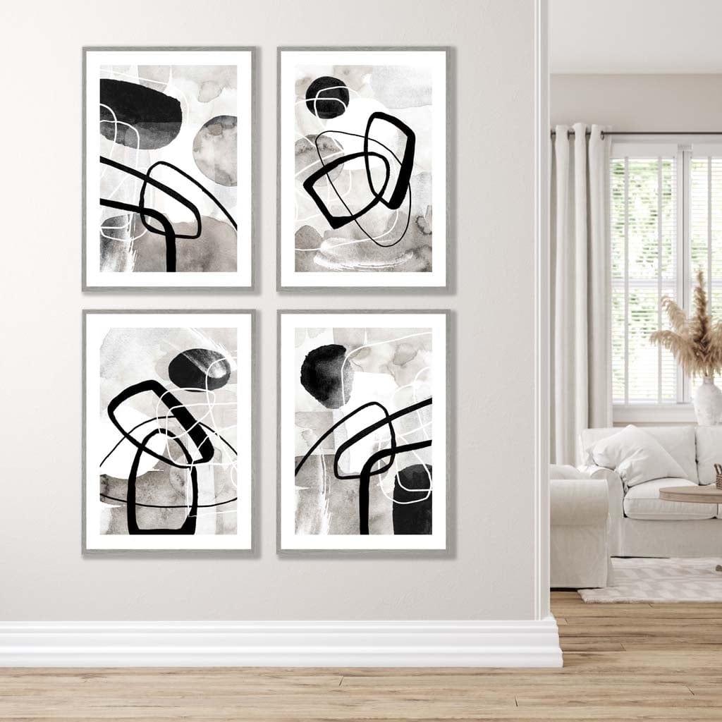 A Set of 4 Black and White Abstract Wall Art in Light Grey Wooden Frames featuring watercolour shapes