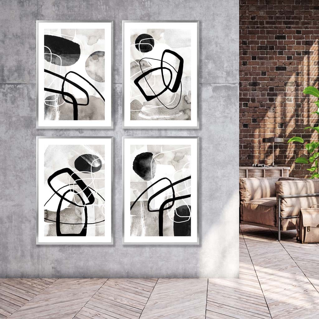 A Set of 4 Black and White Abstract Wall Art in Silver Frames featuring watercolour shapes