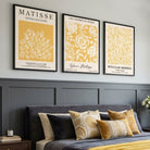 Luxury Bedroom showcasing a Set of 3 Matisse & William Morris Floral in Yellow Framed Wall Art with Black Wooden Frames