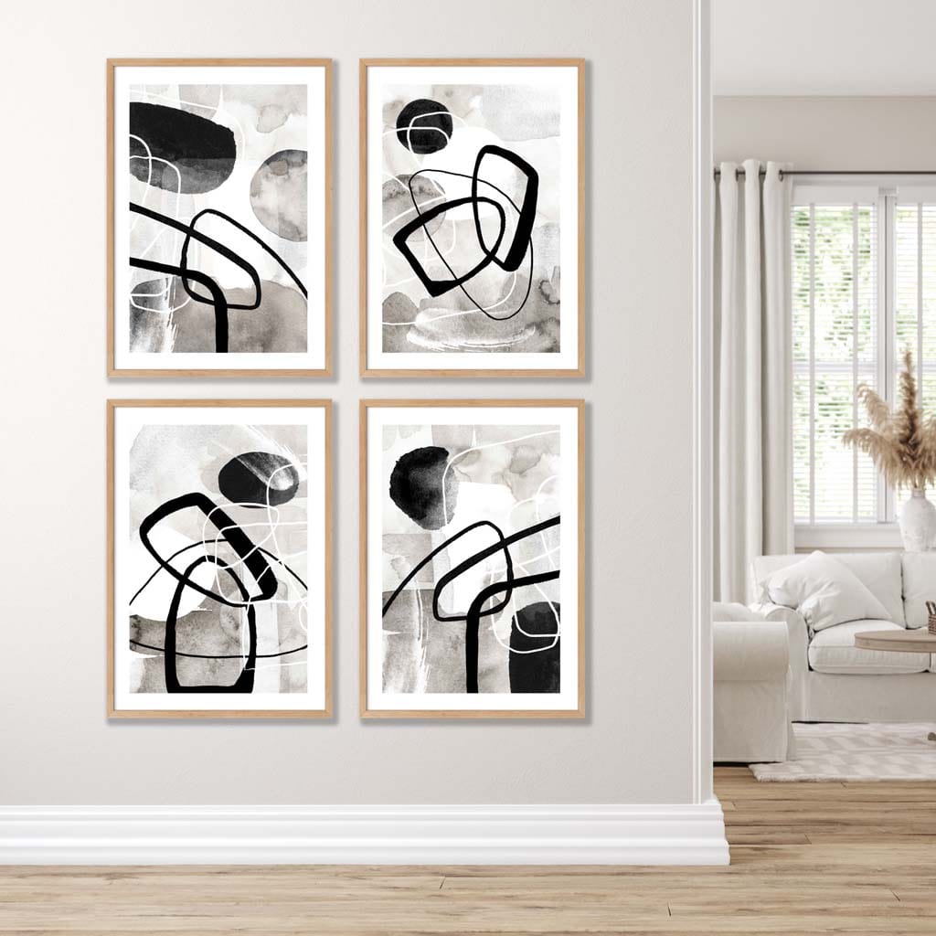 A Set of 4 Black and White Abstract Wall Art in Oak Frames featuring watercolour shapes