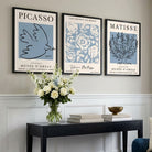 Set of 3 Minimal Picasso,Matisse Light Blue Nature Themed Framed Wall Art with Black Wooden Frames in a stylish hallway