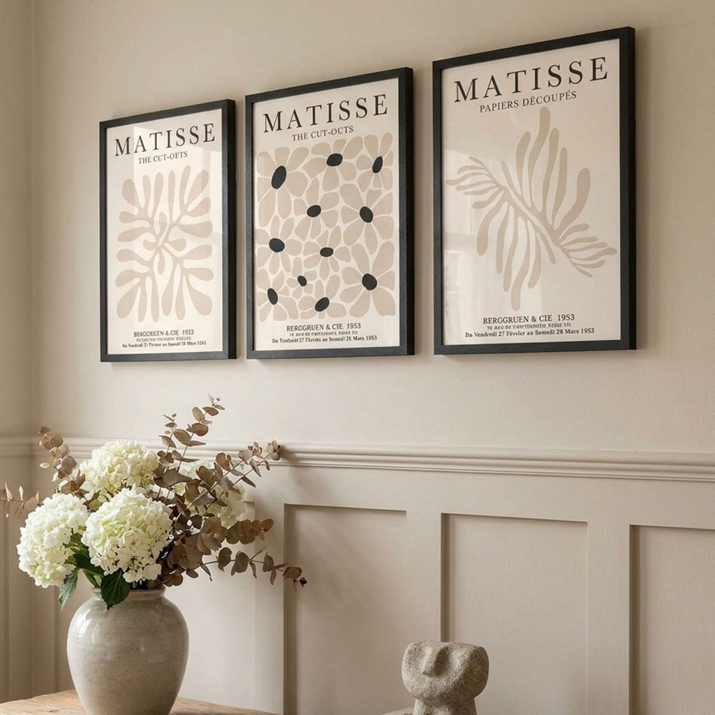 Three framed artworks with 'Matisse' branding on a wall with decorative elements.