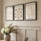 Three framed artworks with 'Matisse' branding on a wall with decorative elements.